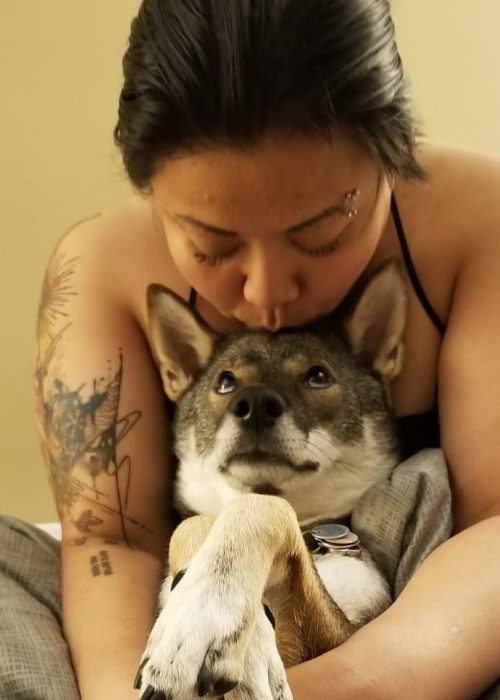 women cuddling a dog
