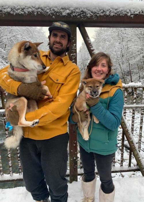 man and women each holding a dog